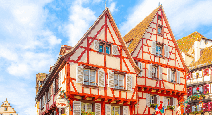 Colorful Grand Rue street of shops and sidewalk cafes in the medieval old town of Colmar, France
