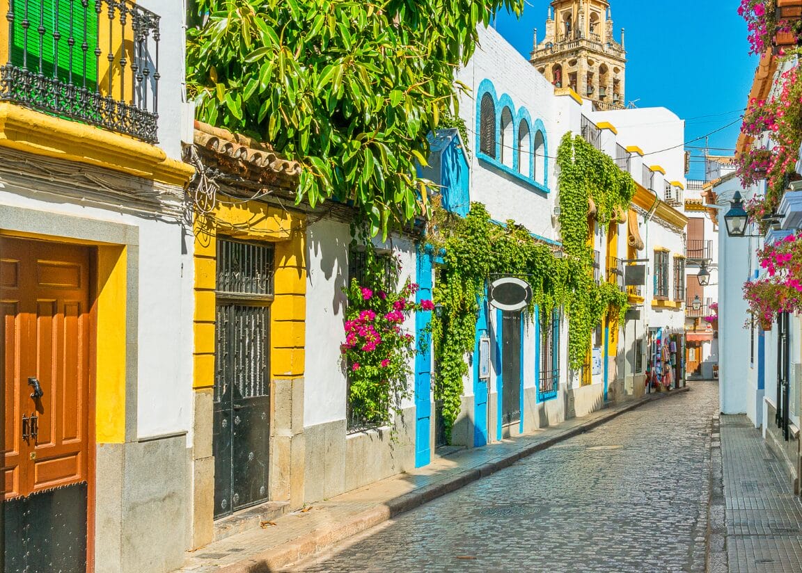 Banner | Scenic sight in the picturesque Cordoba jewish quarter with the bell tower of the Mosque Cathedral. Andalusia, Spain - New
